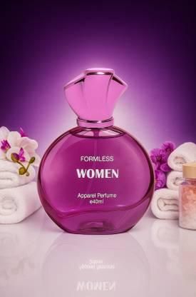 Purple perfume bottle labeled 'Formless Women' on a white surface with flowers and candles.